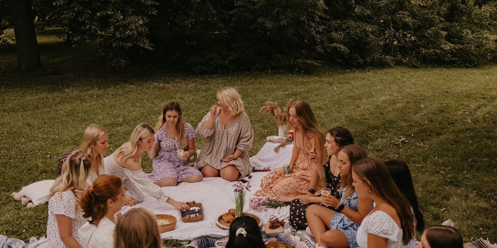 A circle of diverse women sitting together in warm natural light - the SBW community